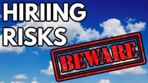 blue sky background with a beware sign for hiring risks