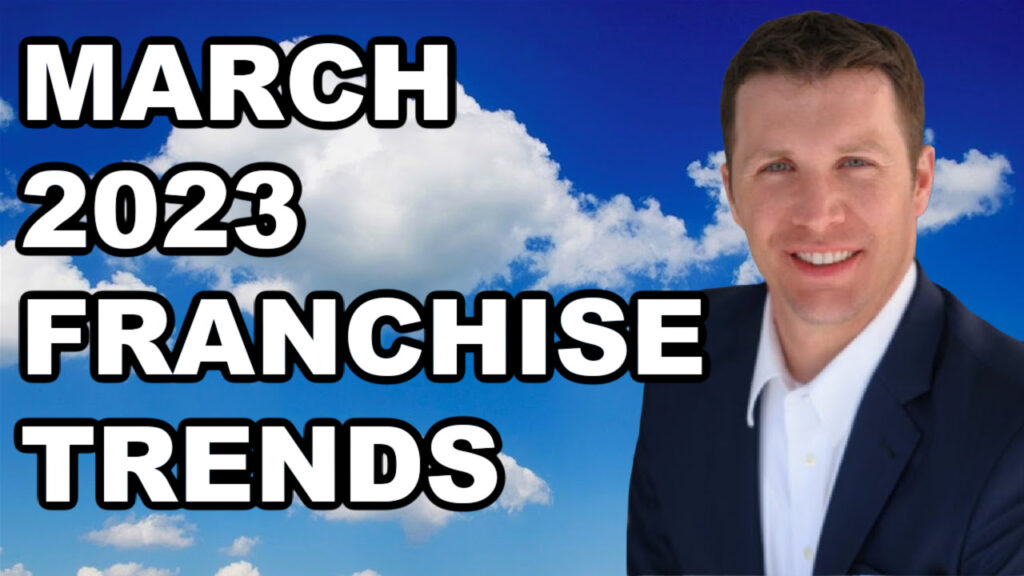 A man in a suit showcasing franchise sales with the words March 2023 franchise trends.