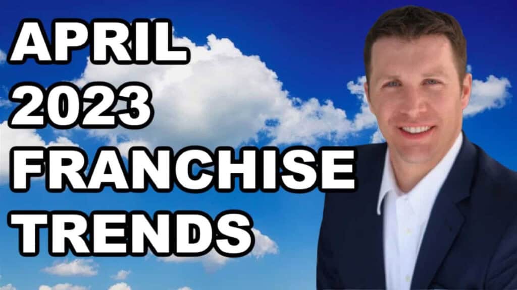 A professional man in a suit against a sky background with clouds.
