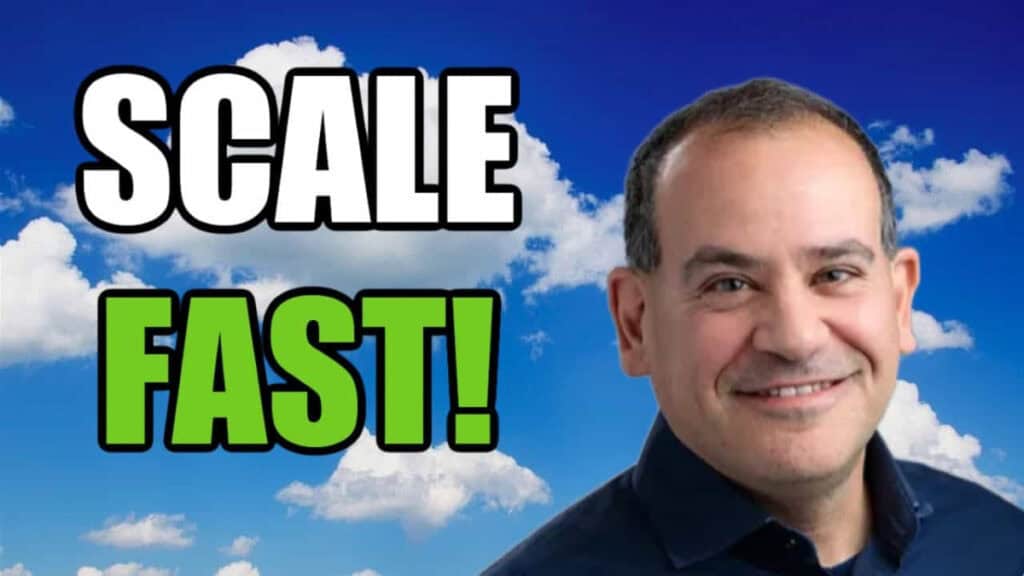 A man smiling in front of a cloudy sky with the words scale fast.