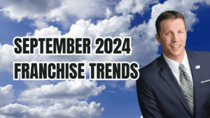 A professional man in a suit alongside bold text reading "September 2024 Franchise Trends" against a sky background with clouds.